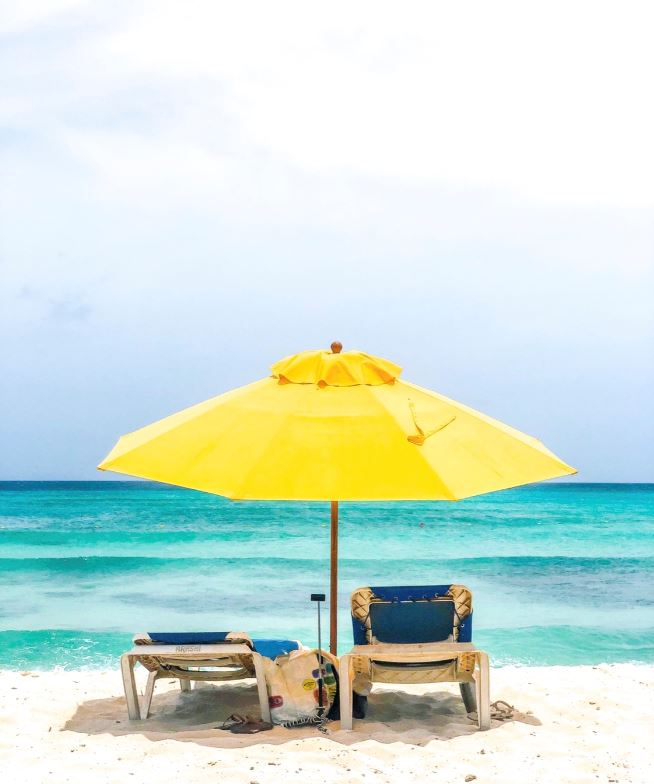 Beach chairs in Aruba with Yellow umbrella