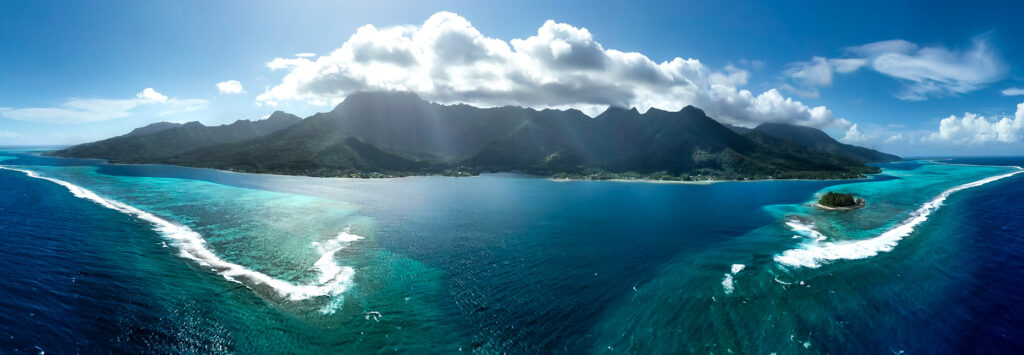 drone image of the island of Moorea with the lagoon and pass