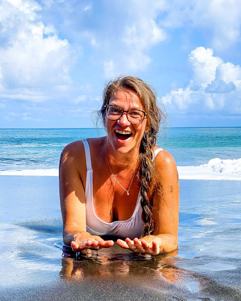 Ashley on a black sand beach Tahiti French Polynesia