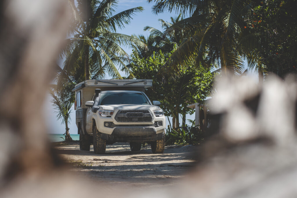 Toyota Tacoma with Four Wheel Camper on the beach in Tulum Mexico