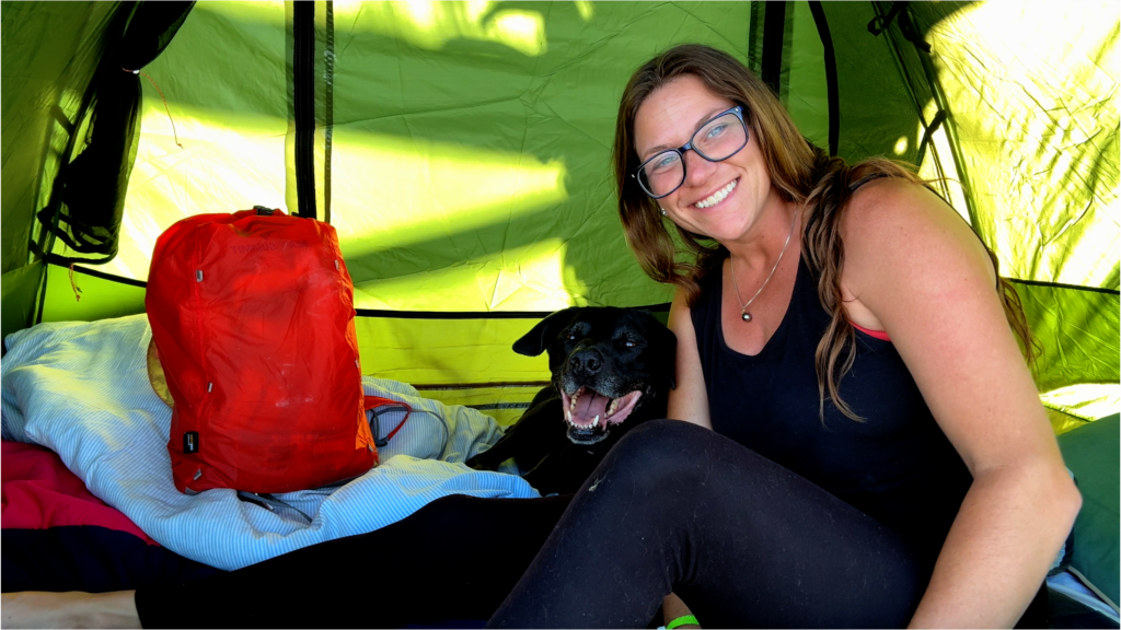 Girl and her dog camping at El Espíritu de la Montaña in El Salvador. 